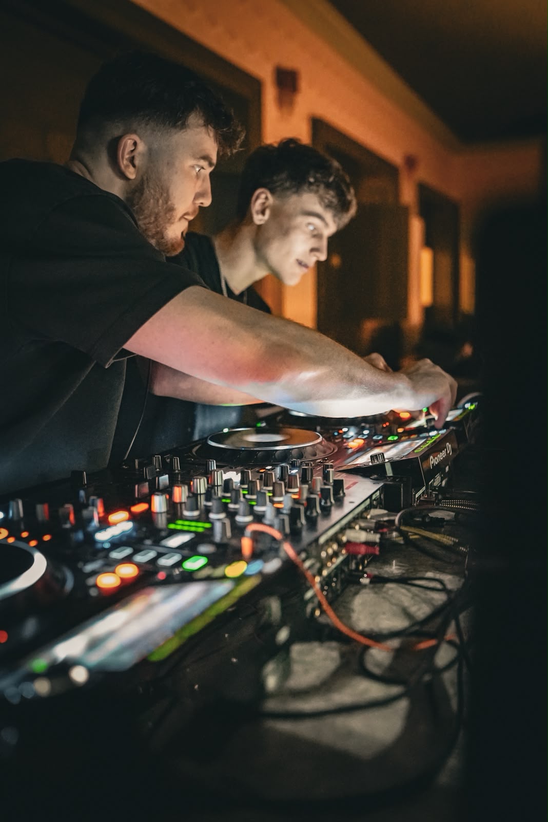 TITAN guiding a DJ through a mix at the decks